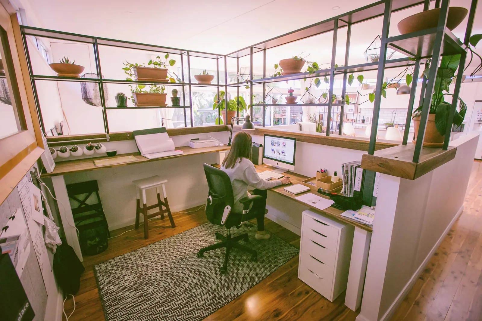 A bright home office with timber desk and shelving